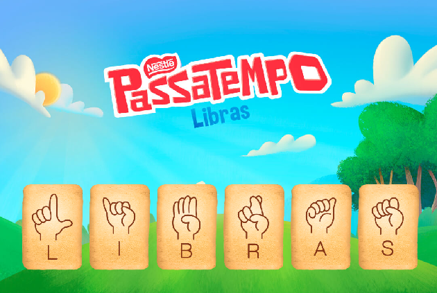 No topo em letras vermelhas o nome da marca Nestlè e da bolacha passatempo. Fundo céu azul uma árvore à direita, nuvens e sol no topo. Abaixo bolachas lado a lado uma com cada letra do alfabeto manual formando a palavra Libras. E abaixo duas crianças sinalizando. bolacha com o alfabeto manual